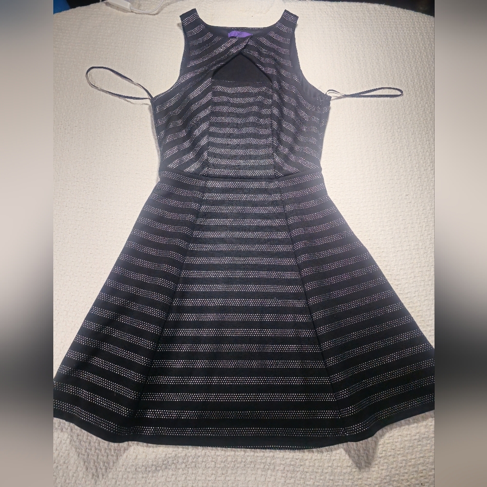 Black Flared dress with metal dot design.